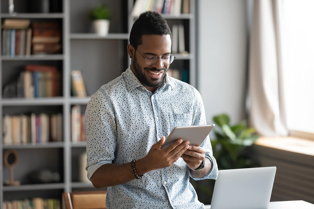 Entrepreneur works on tablet in a home office