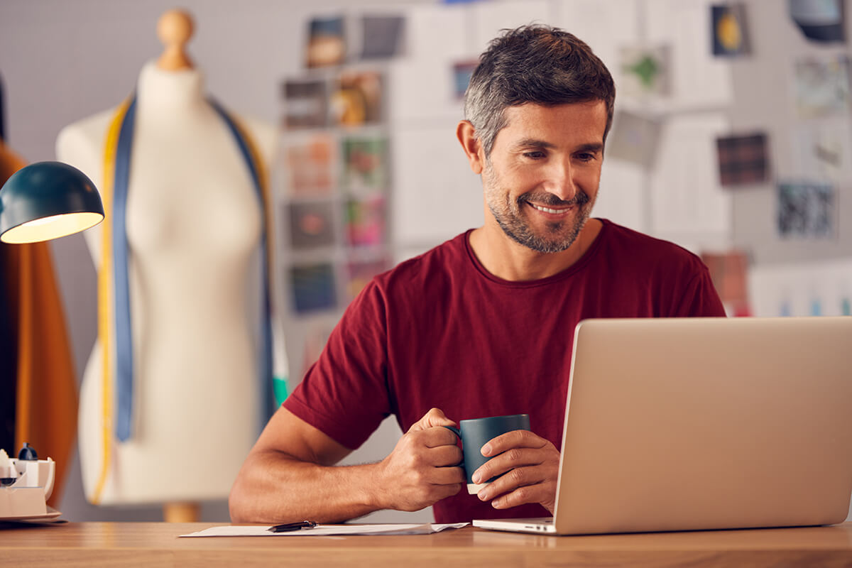 Business owner works on laptop from home